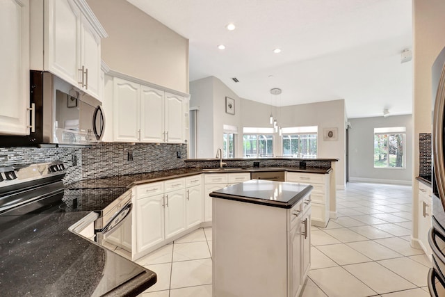 kitchen featuring a kitchen island, hanging light fixtures, electric range, white cabinetry, and light tile floors