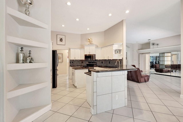 kitchen featuring stainless steel appliances, tasteful backsplash, white cabinets, sink, and light tile floors