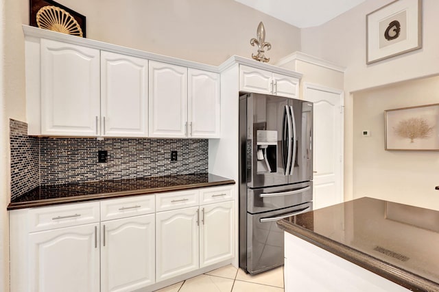 kitchen with backsplash, stainless steel fridge with ice dispenser, white cabinetry, and light tile floors