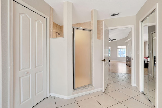 bathroom featuring wood-type flooring, ceiling fan, and a shower with door