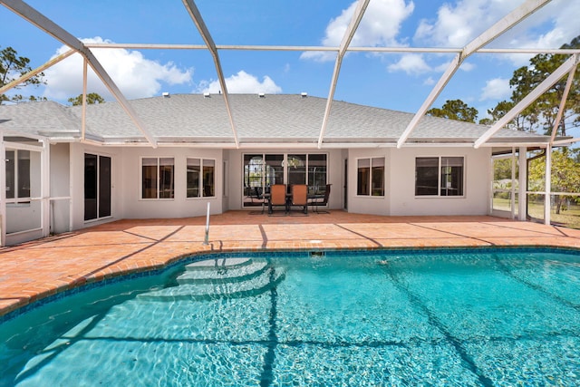 view of swimming pool with a patio and glass enclosure