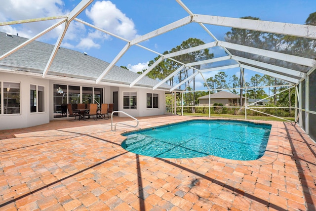 view of swimming pool with a lanai and a patio area