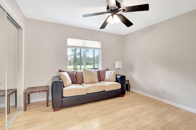 living room featuring ceiling fan and light wood-type flooring