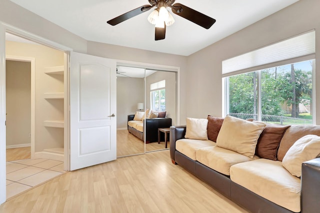 tiled living room featuring ceiling fan and plenty of natural light