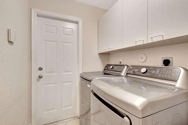 laundry area with cabinets, washing machine and dryer, and electric dryer hookup