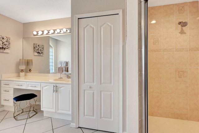 bathroom featuring oversized vanity, tile floors, and a shower with shower door