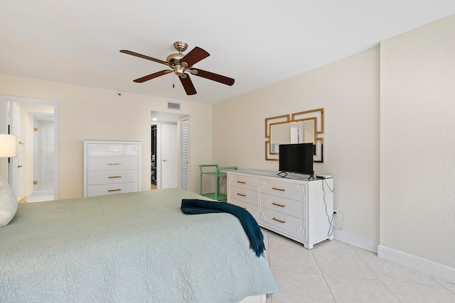 bedroom featuring connected bathroom, ceiling fan, and light tile flooring