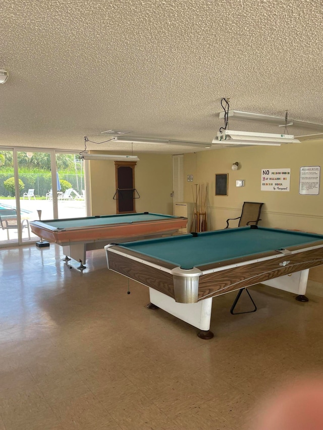 playroom with a textured ceiling, tile floors, and pool table