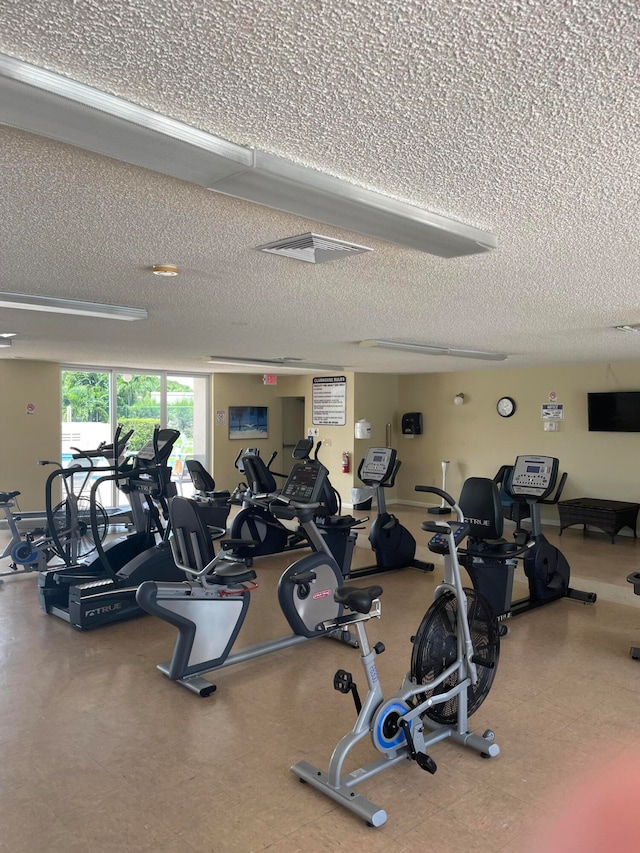 workout area featuring a textured ceiling