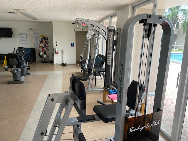 workout area featuring a textured ceiling