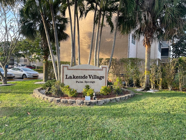 community / neighborhood sign with a lawn