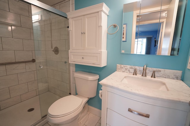 bathroom with a shower with shower door, toilet, tile floors, and large vanity