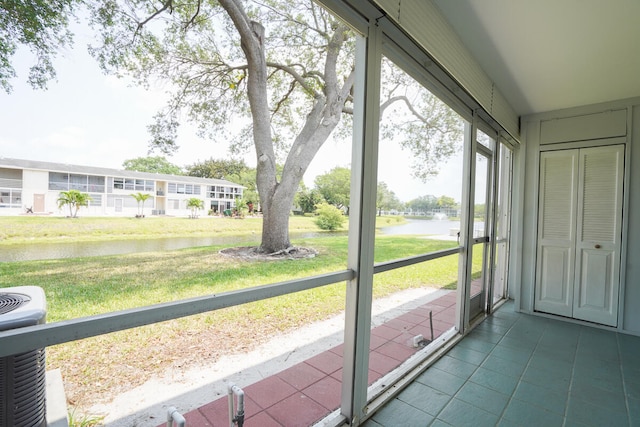 unfurnished sunroom with a water view