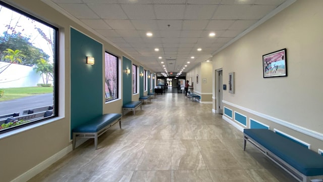 corridor featuring tile flooring and a drop ceiling