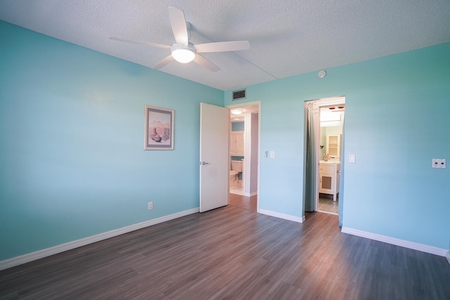 unfurnished bedroom with ceiling fan, a textured ceiling, and dark wood-type flooring