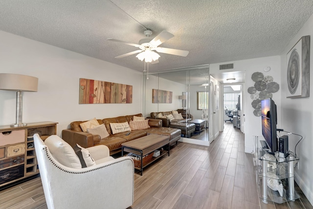 66 Capri B, Delray Beach, FL 33484 - living room with a textured ceiling, ceiling fan, and wood finished floors