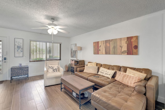 66 Capri B, Delray Beach, FL 33484 - living area with a ceiling fan, a textured ceiling, wood finished floors, and baseboards