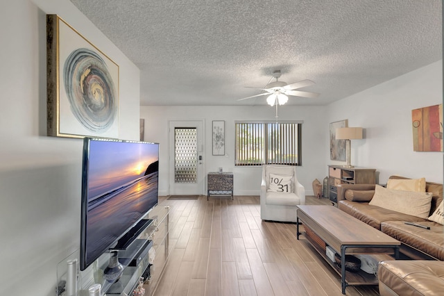 66 Capri B, Delray Beach, FL 33484 - living area featuring a ceiling fan, a textured ceiling, wood finished floors, and baseboards