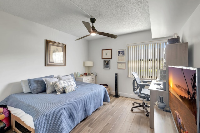 66 Capri B, Delray Beach, FL 33484 - bedroom featuring baseboards, light wood-type flooring, an office area, ceiling fan, and a textured ceiling