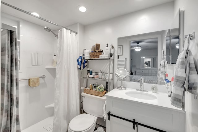 66 Capri B, Delray Beach, FL 33484 - bathroom featuring a shower stall, toilet, ceiling fan, and vanity