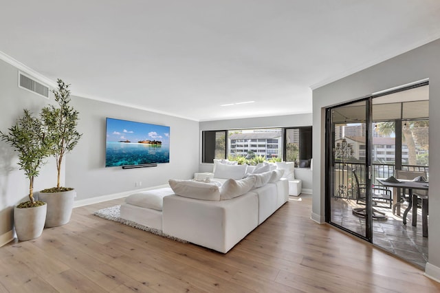 living room with crown molding and hardwood / wood-style flooring