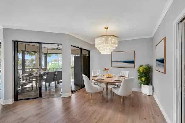 dining room featuring a chandelier, crown molding, and wood-type flooring