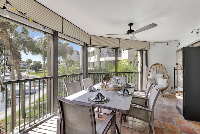 sunroom / solarium featuring plenty of natural light and ceiling fan