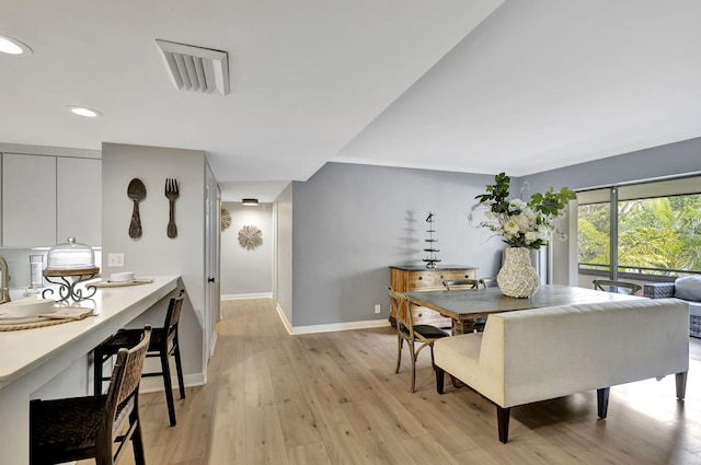 dining space with light wood-type flooring