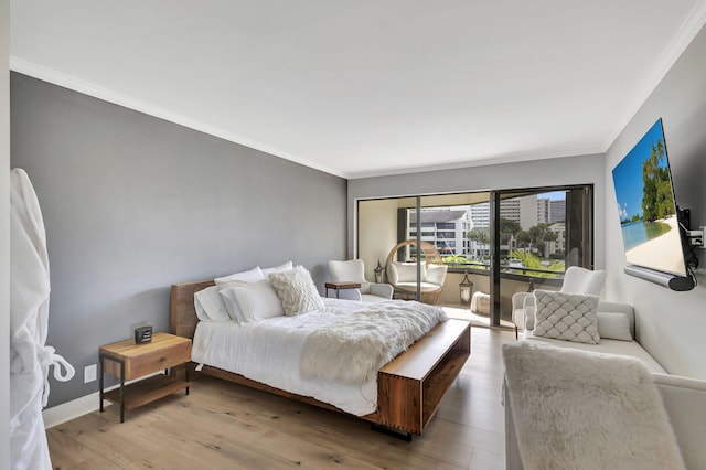 bedroom with hardwood / wood-style flooring and crown molding