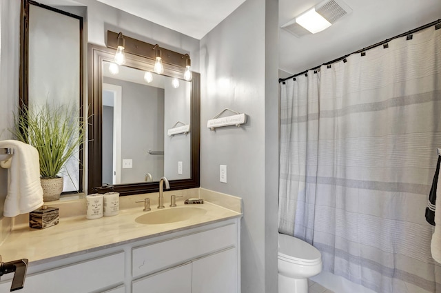 bathroom with tile flooring, vanity, and toilet