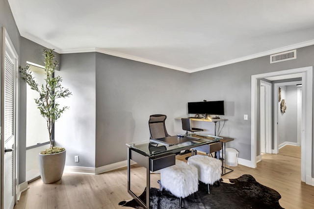 office space featuring ornamental molding and light hardwood / wood-style floors