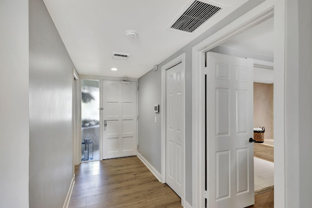 corridor featuring wood-type flooring