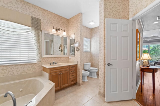 bathroom featuring tile floors, a bath, large vanity, a bidet, and toilet