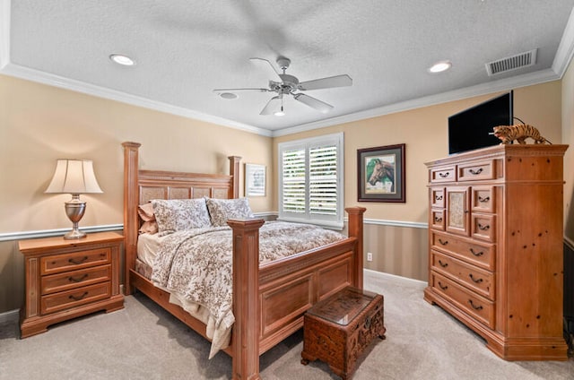 carpeted bedroom featuring a textured ceiling, ceiling fan, and ornamental molding