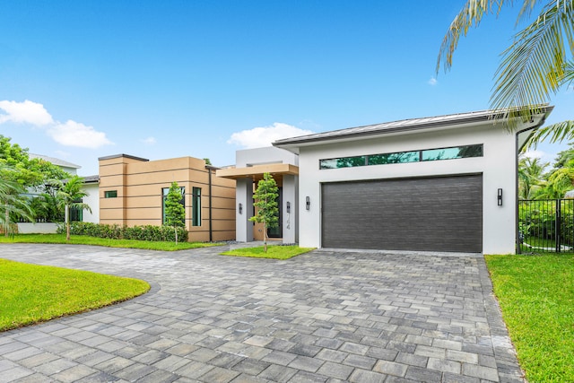 view of front of property with a front lawn and a garage