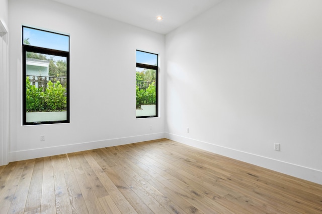 unfurnished room with plenty of natural light and light hardwood / wood-style flooring