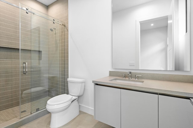 bathroom with vanity, tile patterned flooring, toilet, and a shower with shower door