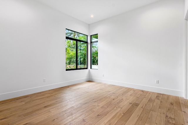 unfurnished room with light wood-type flooring