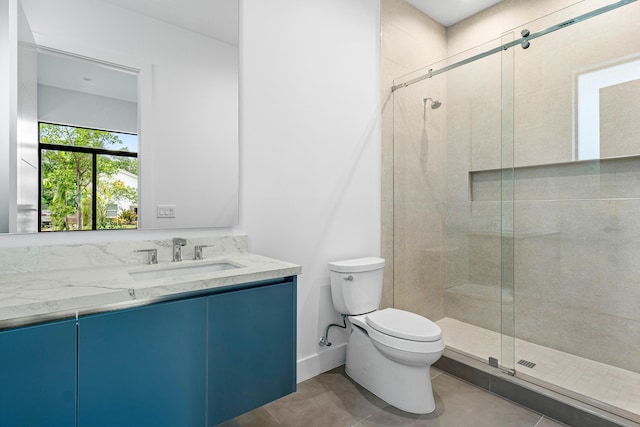 bathroom featuring tile patterned floors, an enclosed shower, vanity, and toilet