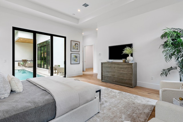 bedroom featuring access to exterior and light hardwood / wood-style flooring