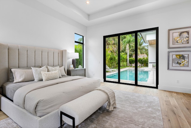 bedroom with access to exterior and light hardwood / wood-style flooring