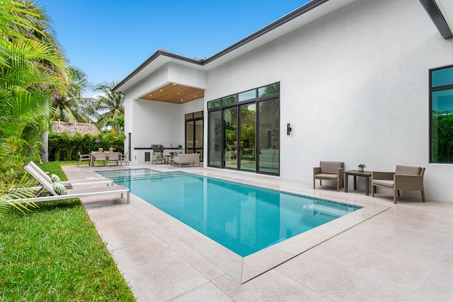 view of pool with ceiling fan and a patio area