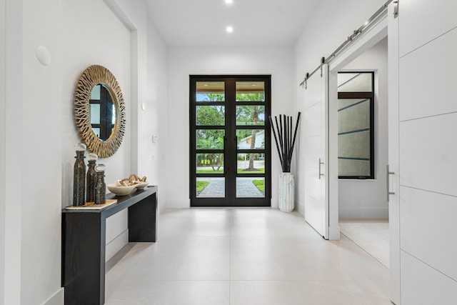 entryway featuring a barn door and french doors