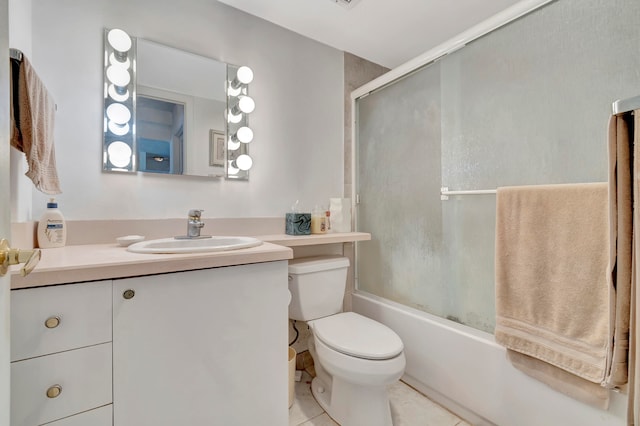 full bathroom featuring toilet, tile flooring, vanity, and shower / bath combination with glass door