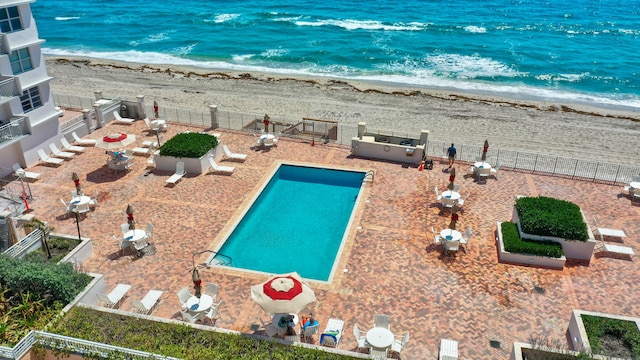 exterior space with a water view and a view of the beach