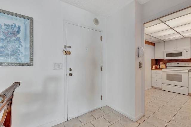 foyer entrance featuring light tile floors