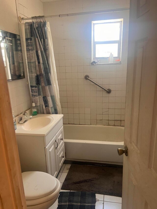 full bathroom featuring shower / bathtub combination with curtain, toilet, tile flooring, and vanity