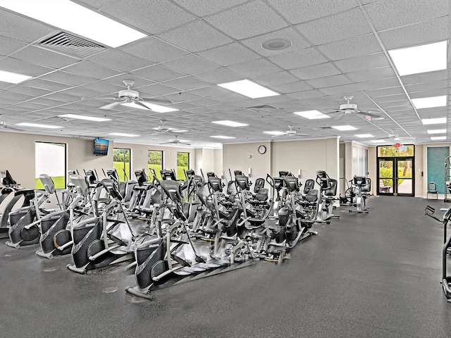 workout area with plenty of natural light, ceiling fan, and a drop ceiling