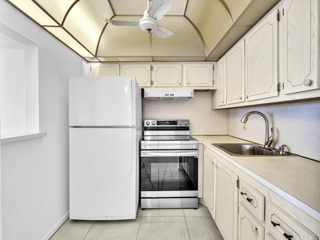 kitchen with ceiling fan, white refrigerator, electric range, light tile floors, and sink