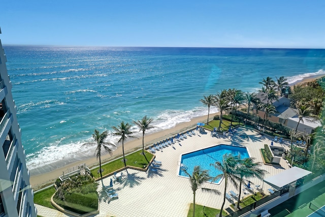 birds eye view of property featuring a beach view and a water view